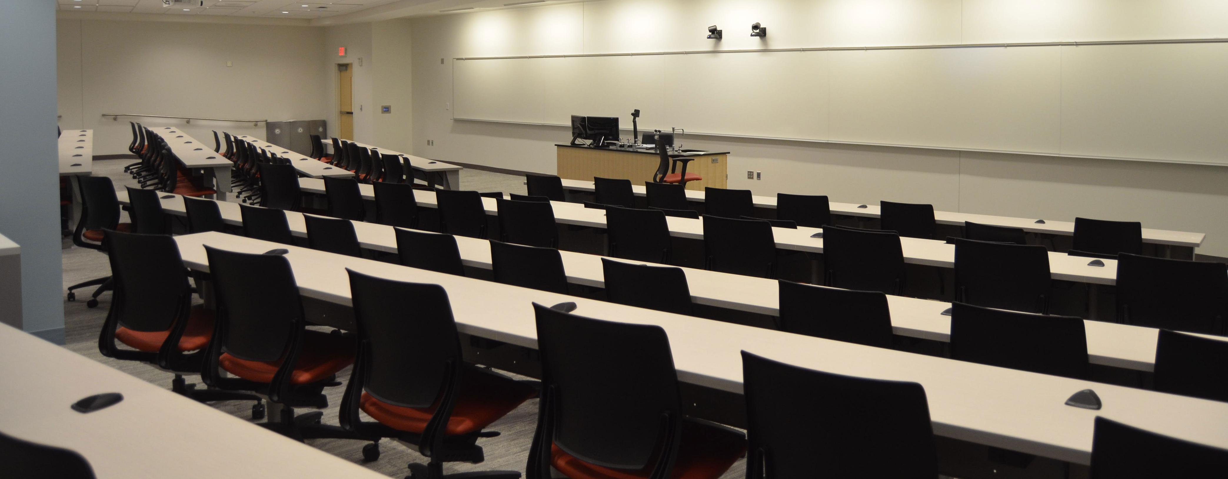 An auditorium with chairs and a whiteboard